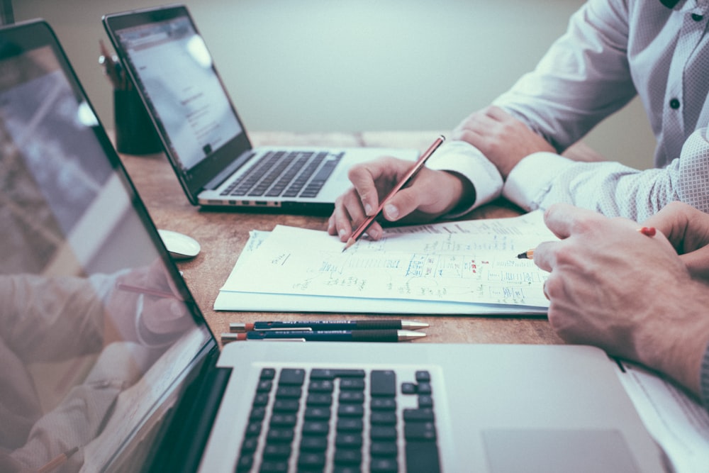 Documentos, calculadora y laptop sobre escritorio de trabajo